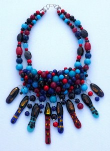 Necklace with multiple townhouse pendants with beads weaved on a wire mesh using turquoise,blue jade, coral and sterling silver