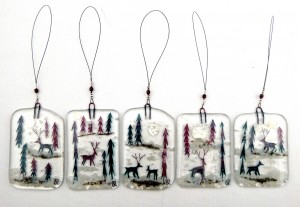 Fused-glass reindeer in snowy forest decorations