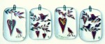 Fused-glass Valentine's Day decorations of birds and hearts hanging from twigs