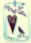 Fused-glass Valentine's Day decoration of a hanging heart and a chirping bird